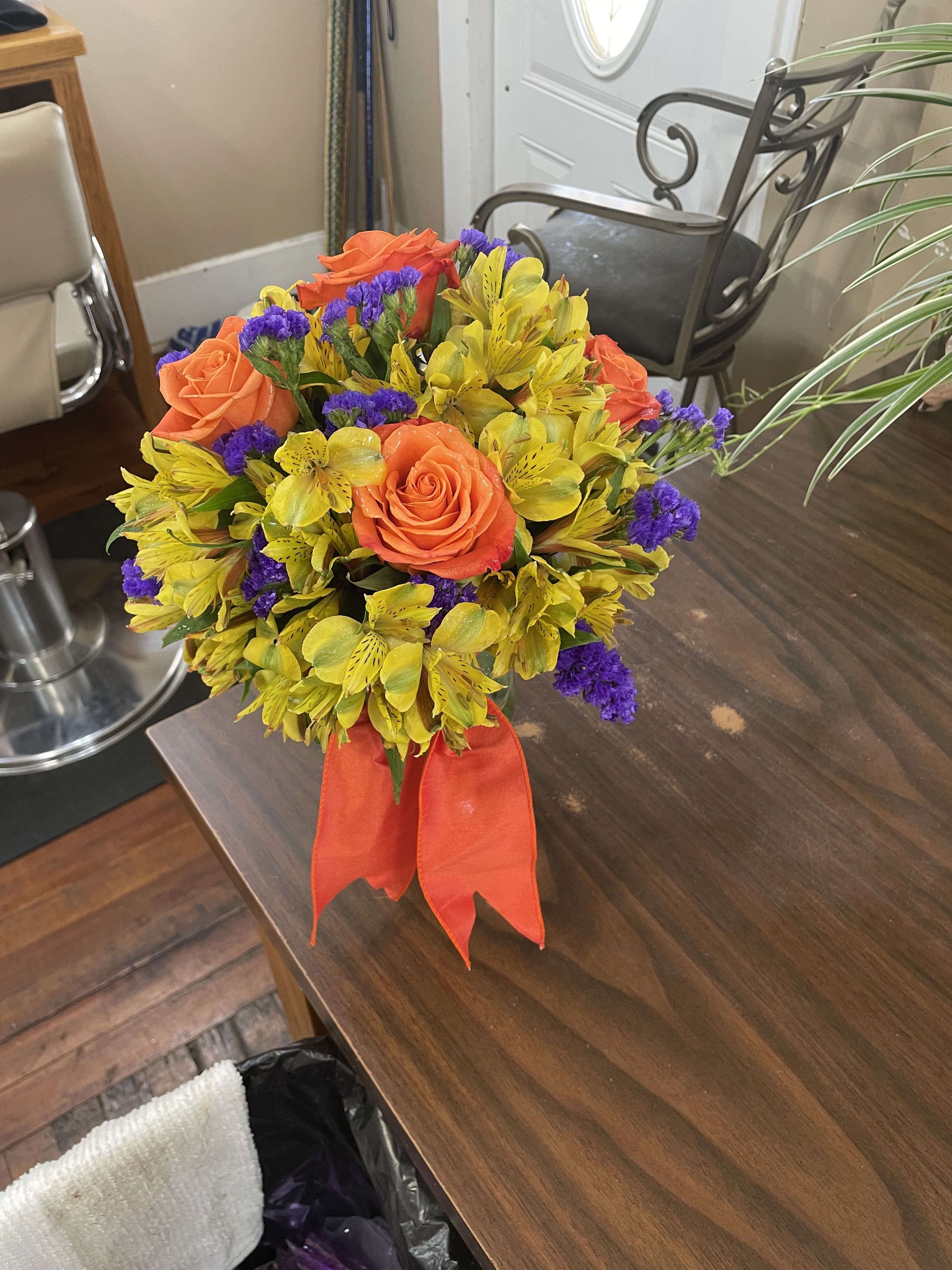 Golden Hugs Bouquet - Show someone how much you care with this bouquet of golden colors, orange roses and purple statice. 