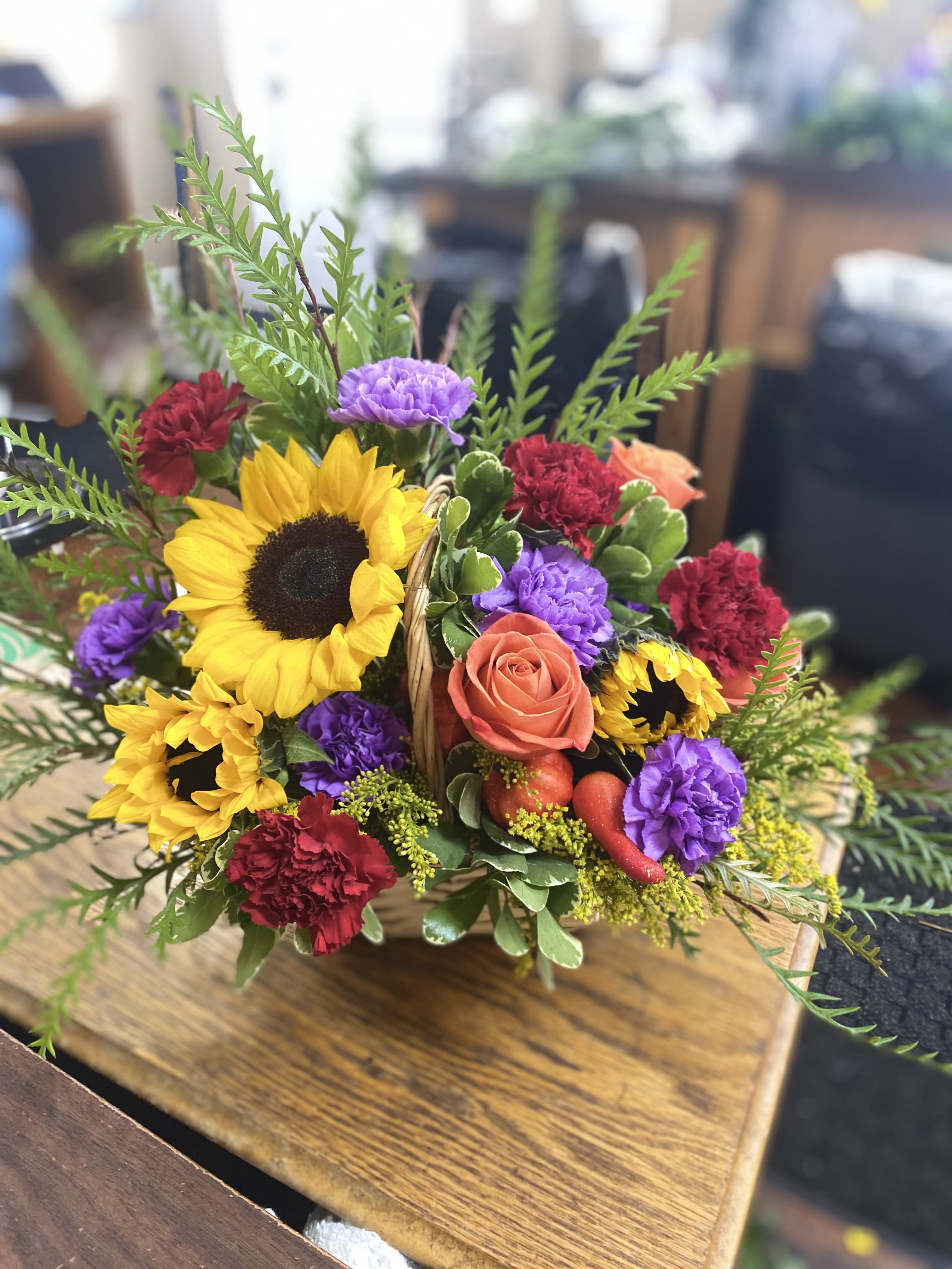 Fresh Sunflower Love Basket  - Mix Sunflower Basket. A designer choice Beautiful Fresh mix of one sunflower and other mixed flowers. Colors and Vase can vary in each arrangement. Raffia Bow