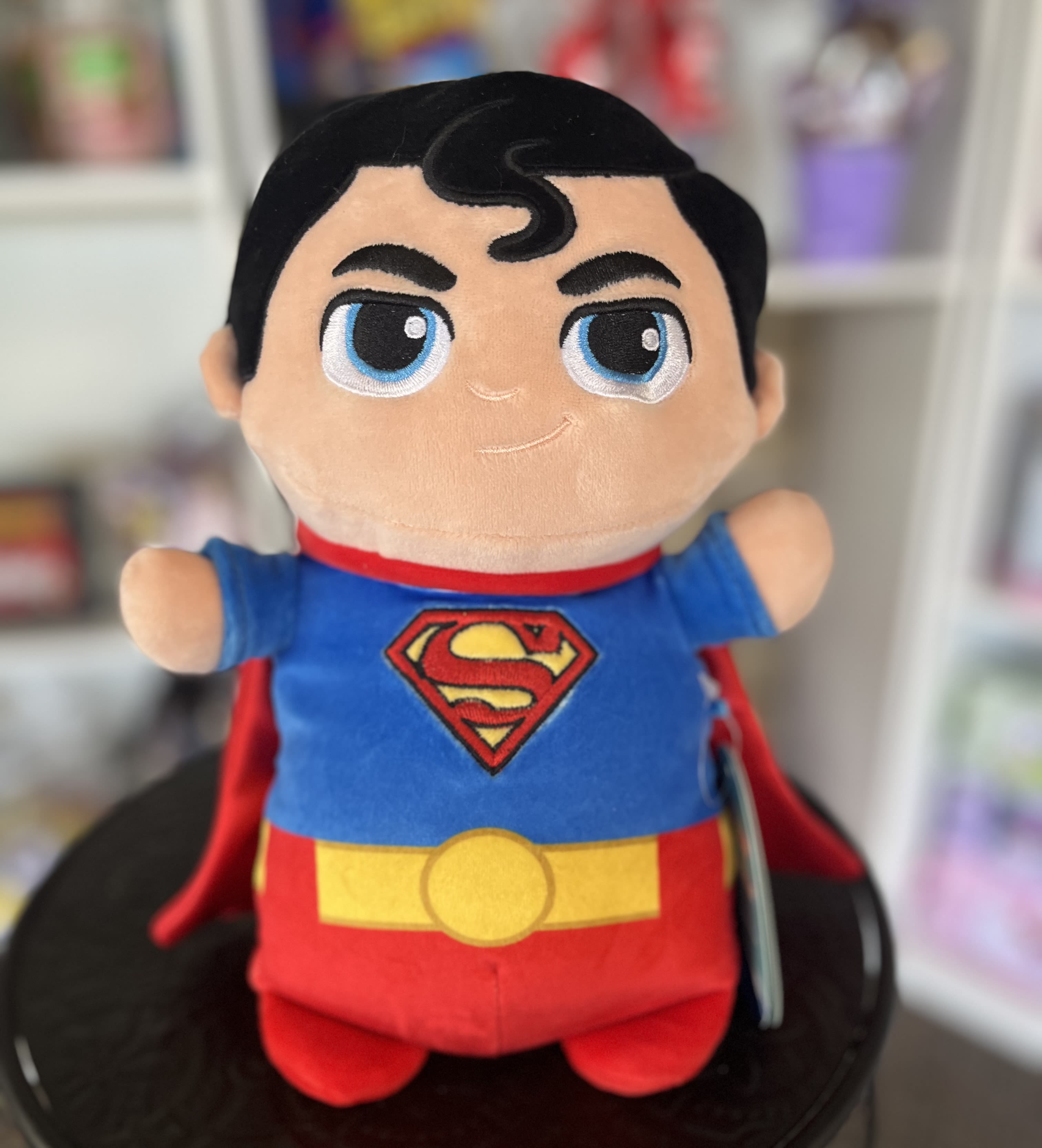 Superman plush toy with a red cape and blue suit