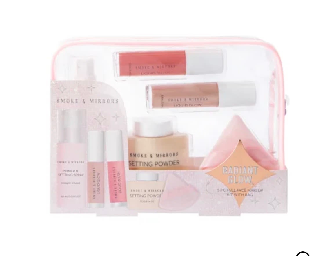 Pink makeup gift set with setting spray, lip gloss, powder, and a pouch