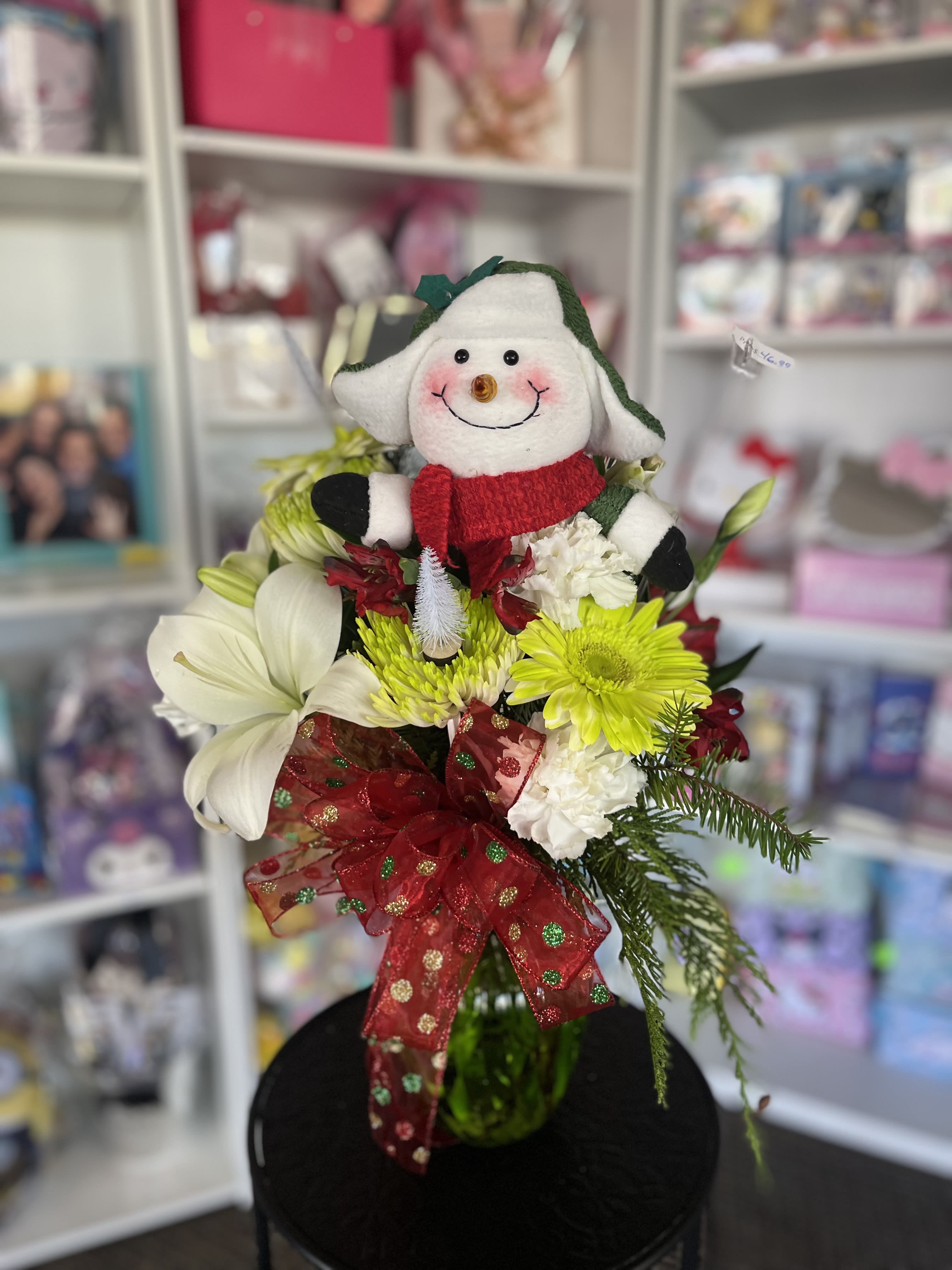 Holiday bouquet with a plush snowman and red ribbon