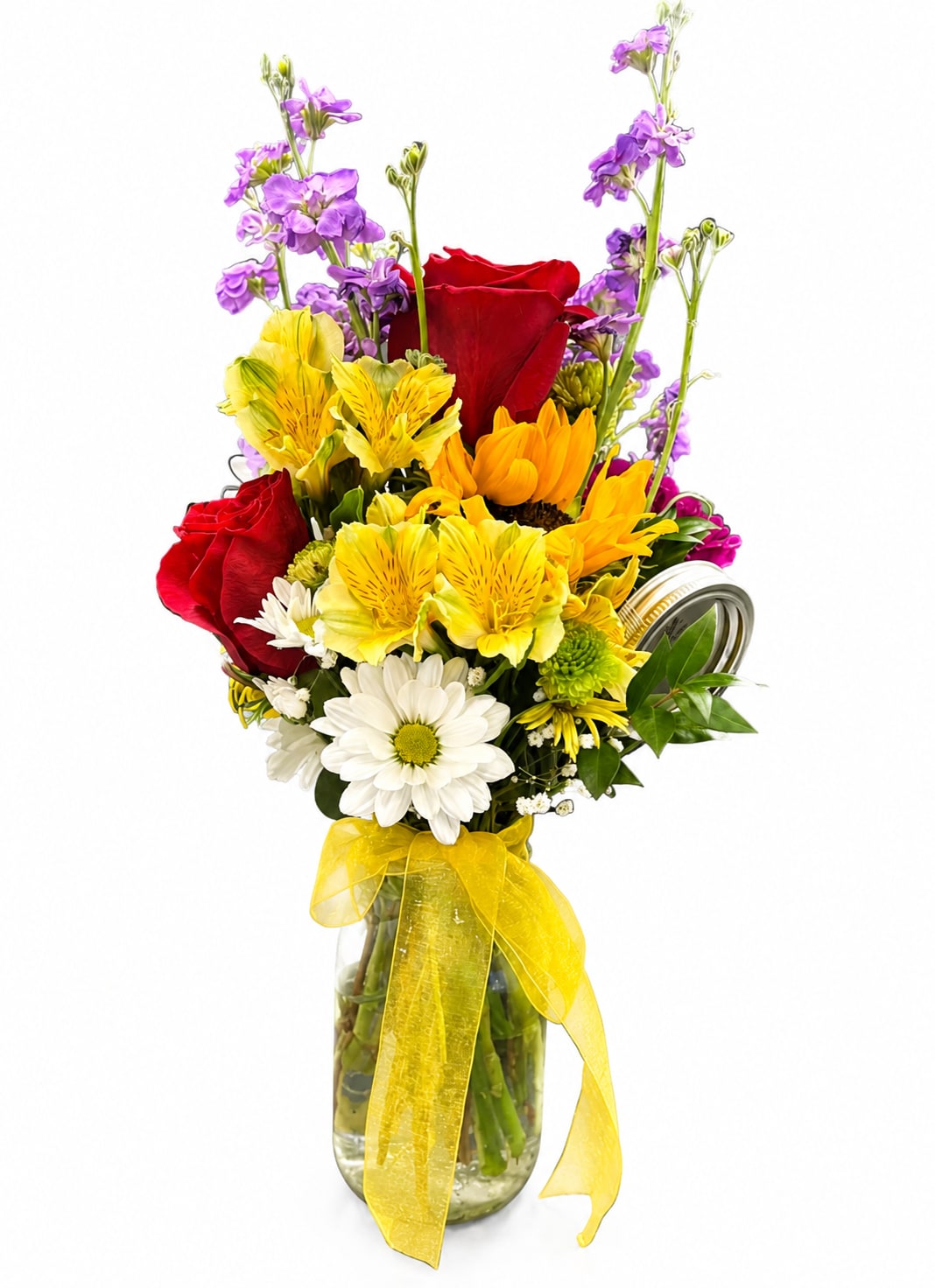 Mixed bouquet of red roses, yellow flowers, and purple blooms in a glass vase with a yellow ribbon