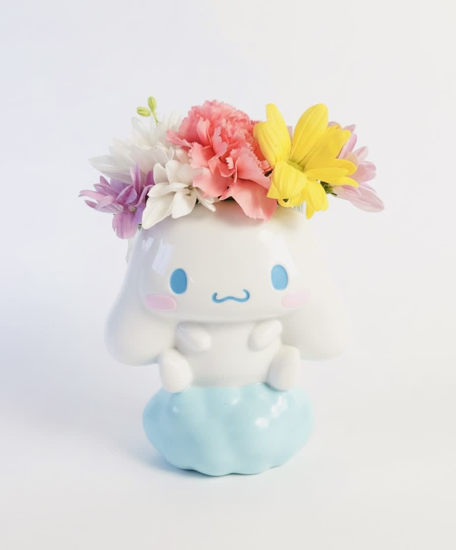 Colorful flowers arranged in a cute ceramic character planter