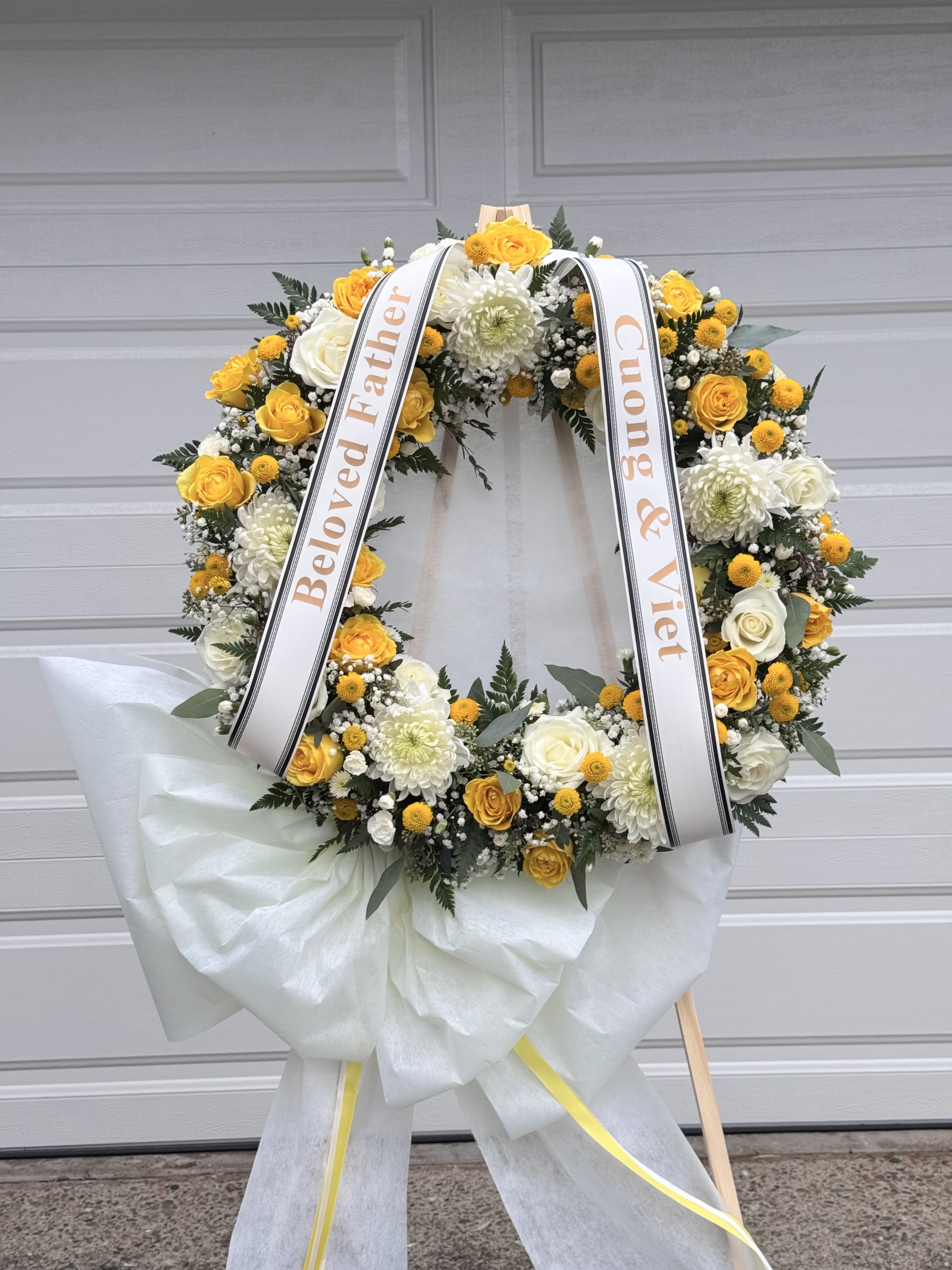 Yellow Wreath - -18 inches Wreath or 24 inches Wreath Include: - 1 wooden stand 66 inches - 2 free Banners with Hand- Written (Max 8 Words each Banner) To Add BANNER MESSAGES ===Please Copy and Paste Below into "Special Instruction" box === Banner 1: (message here) Banner 2: (message here)  *****Please note that this wreath has to order in advance 2 days before delivery date.*****