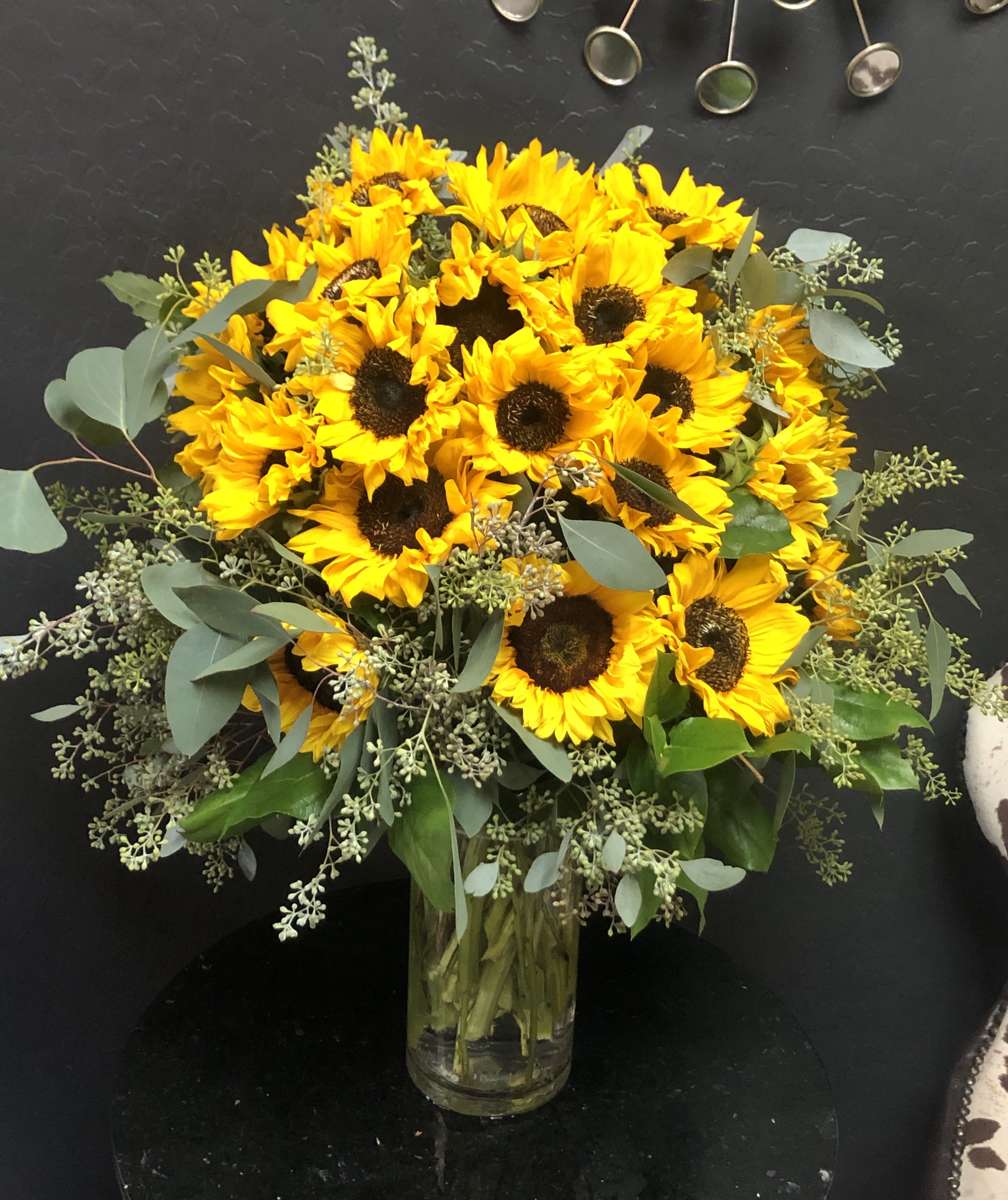 Bouquet of yellow sunflowers in a clear glass vase