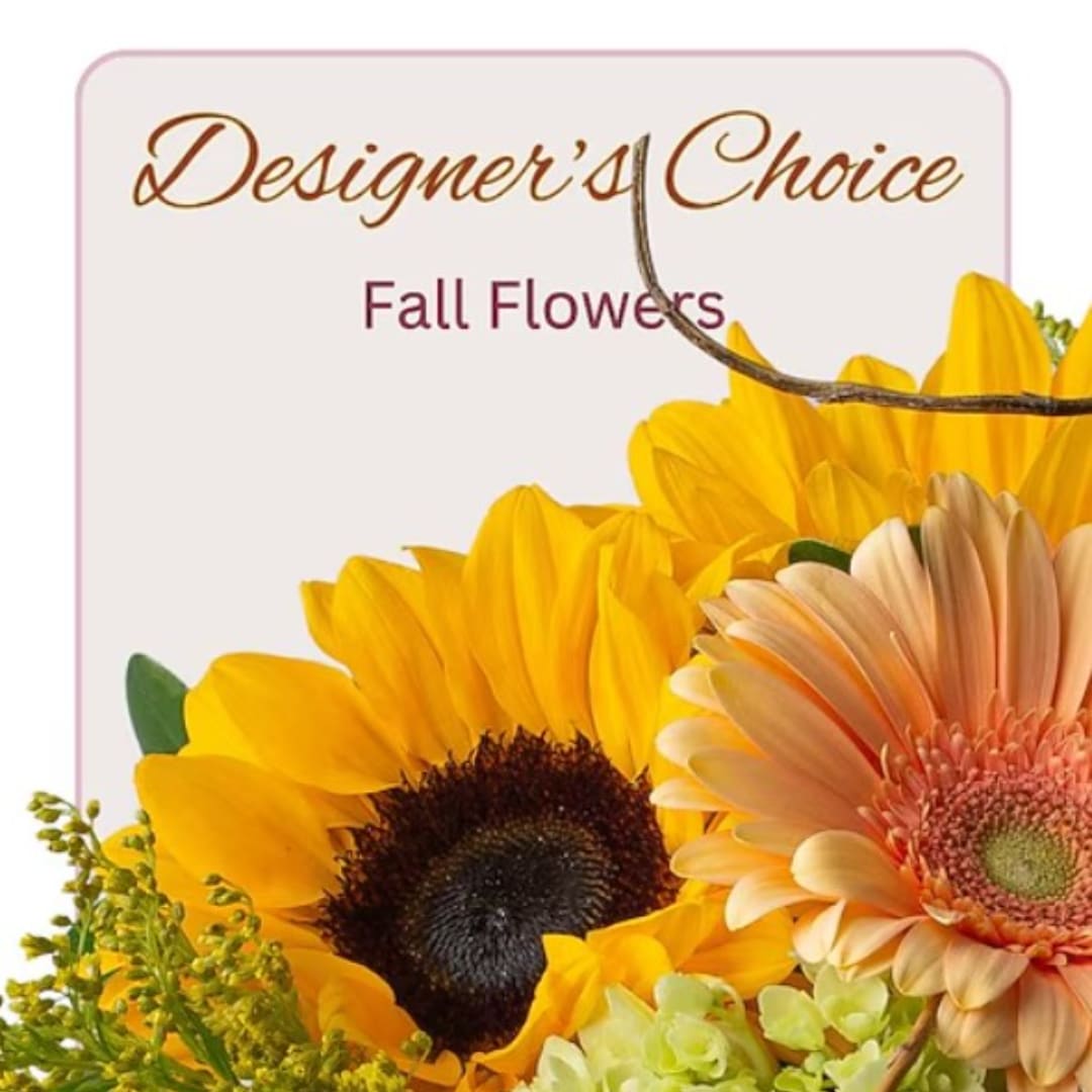Sunflowers and a peach gerbera daisy in a fall floral design