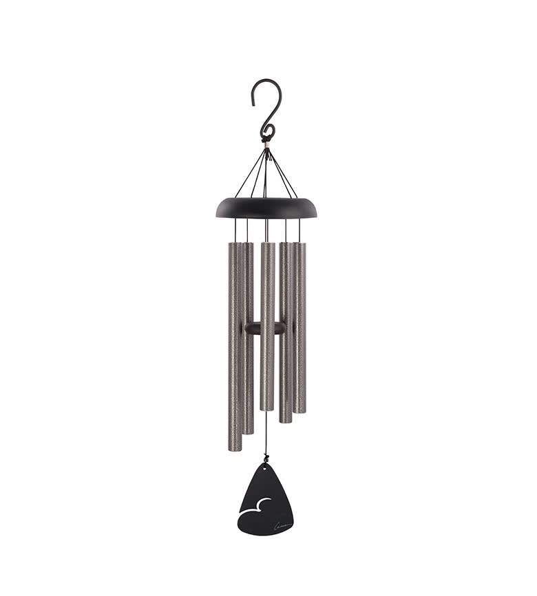 Black and silver wind chime hanging on a white background