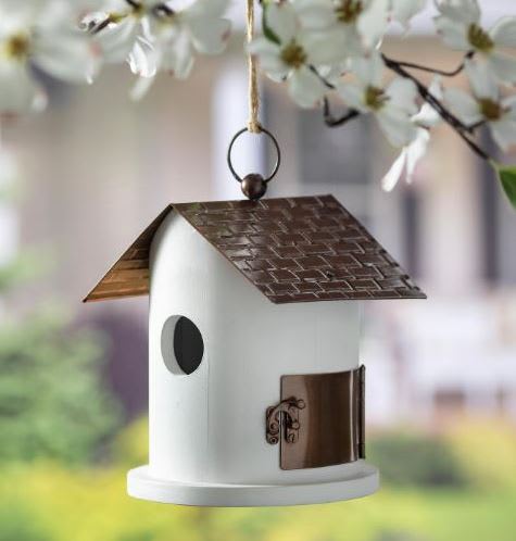 White hanging birdhouse with a brown roof and small round entrance