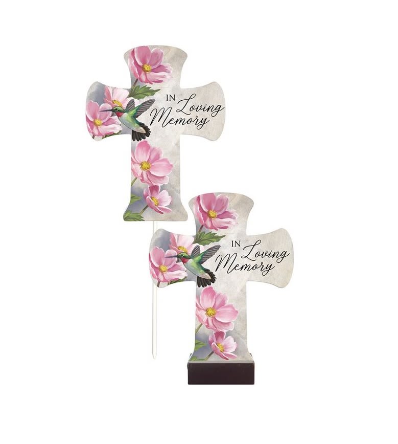 Two cross-shaped memorial plaques with pink flowers and hummingbirds