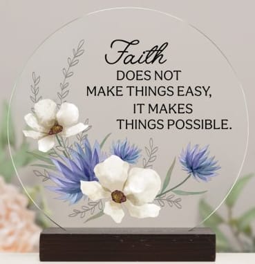 Round acrylic plaque with white and blue floral design and faith quote