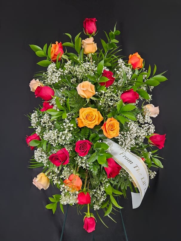Standing wreath of multicolored roses with baby's breath and ribbon