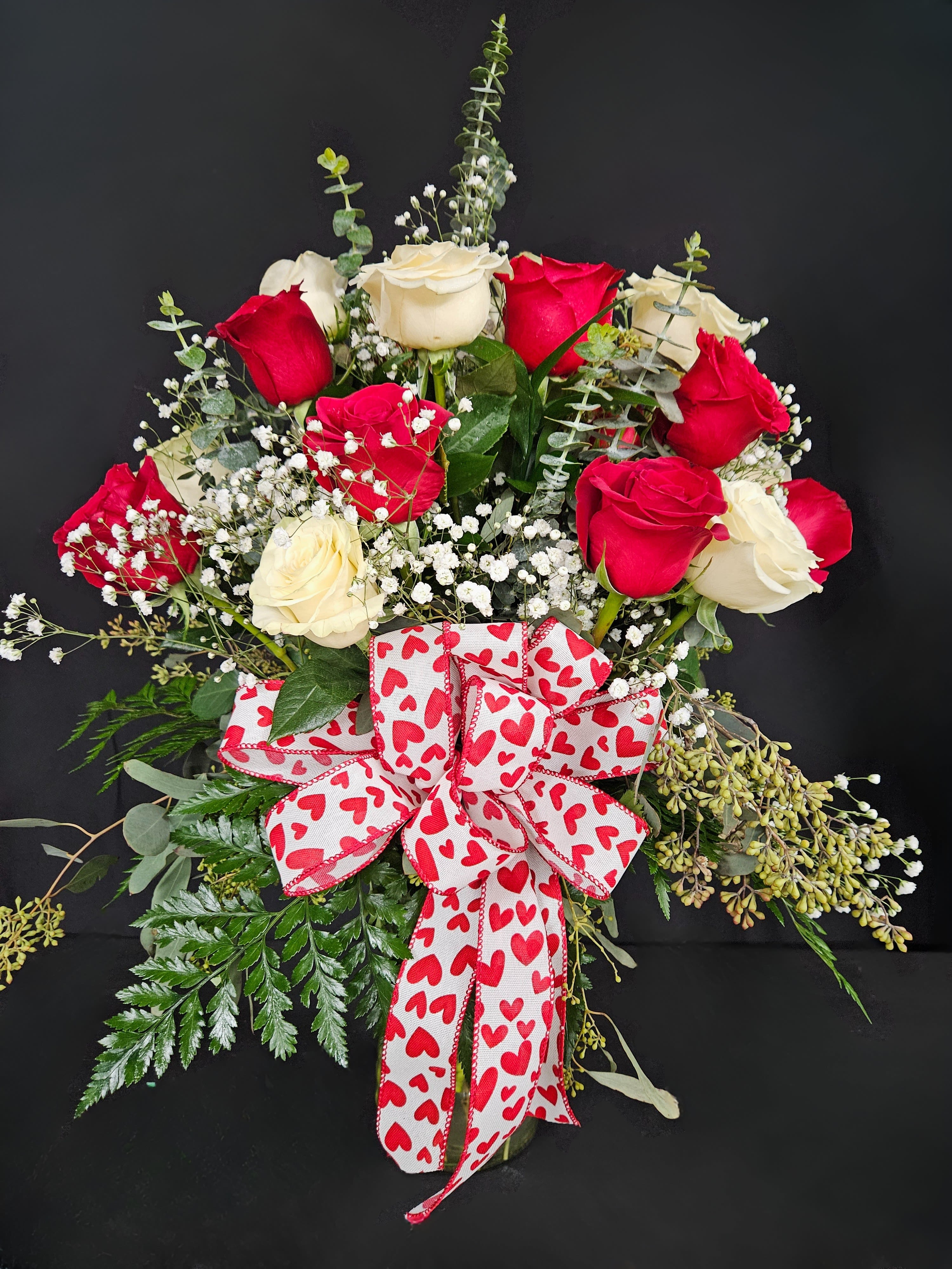 Love Always - 2 Dozen Red &amp; White Roses - Express your love for the number one in your life with this beautiful arrangement of two dozen red and white roses artfully arranged with baby's breath and decorative greens.