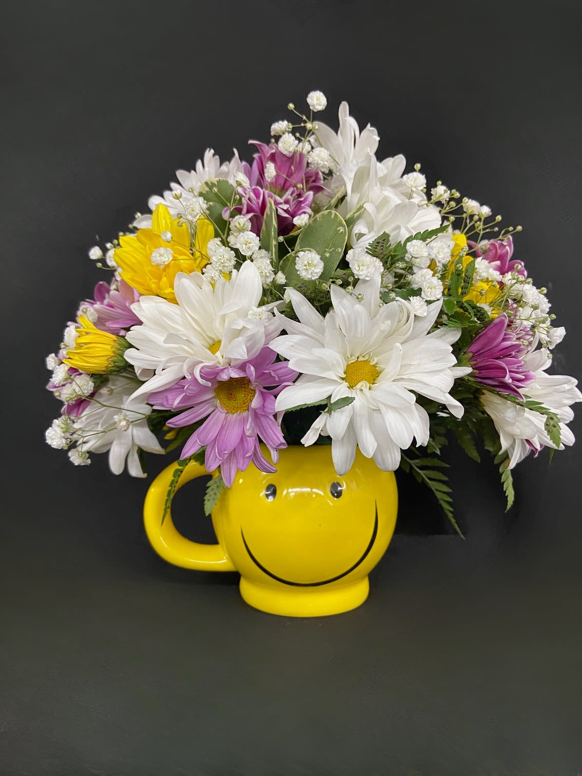 Baby's First Blooms - Celebrate the birth of a new baby with this adorable smiley mug full of daisies. 