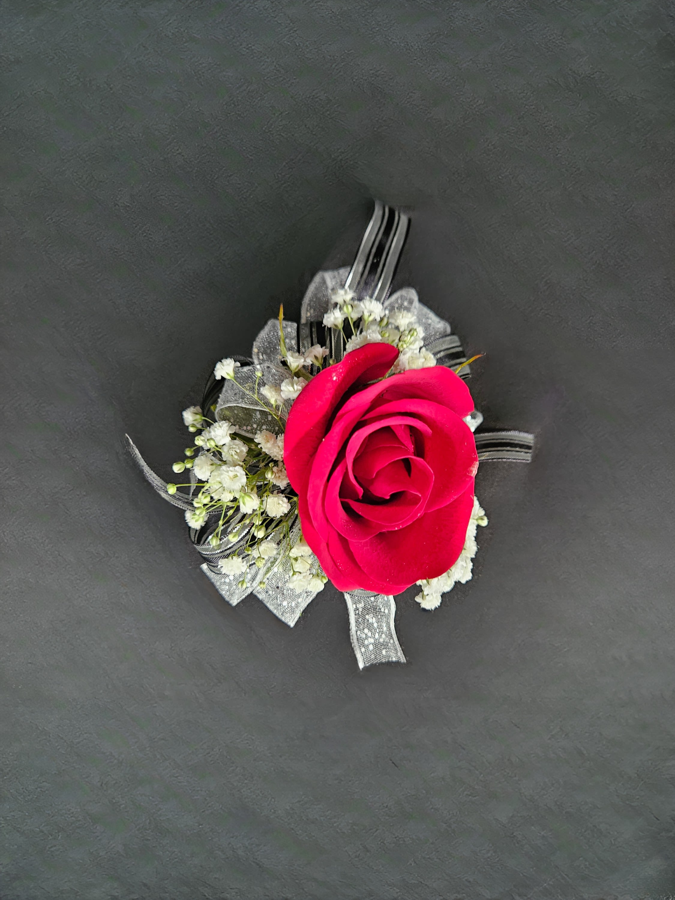 Rose Corsage (Customizable) - A beautiful rose corsage that will compliment any outfit. Please select the flower color you would like, wristlet color and up to 2 ribbon colors from the add-on selections to be included.