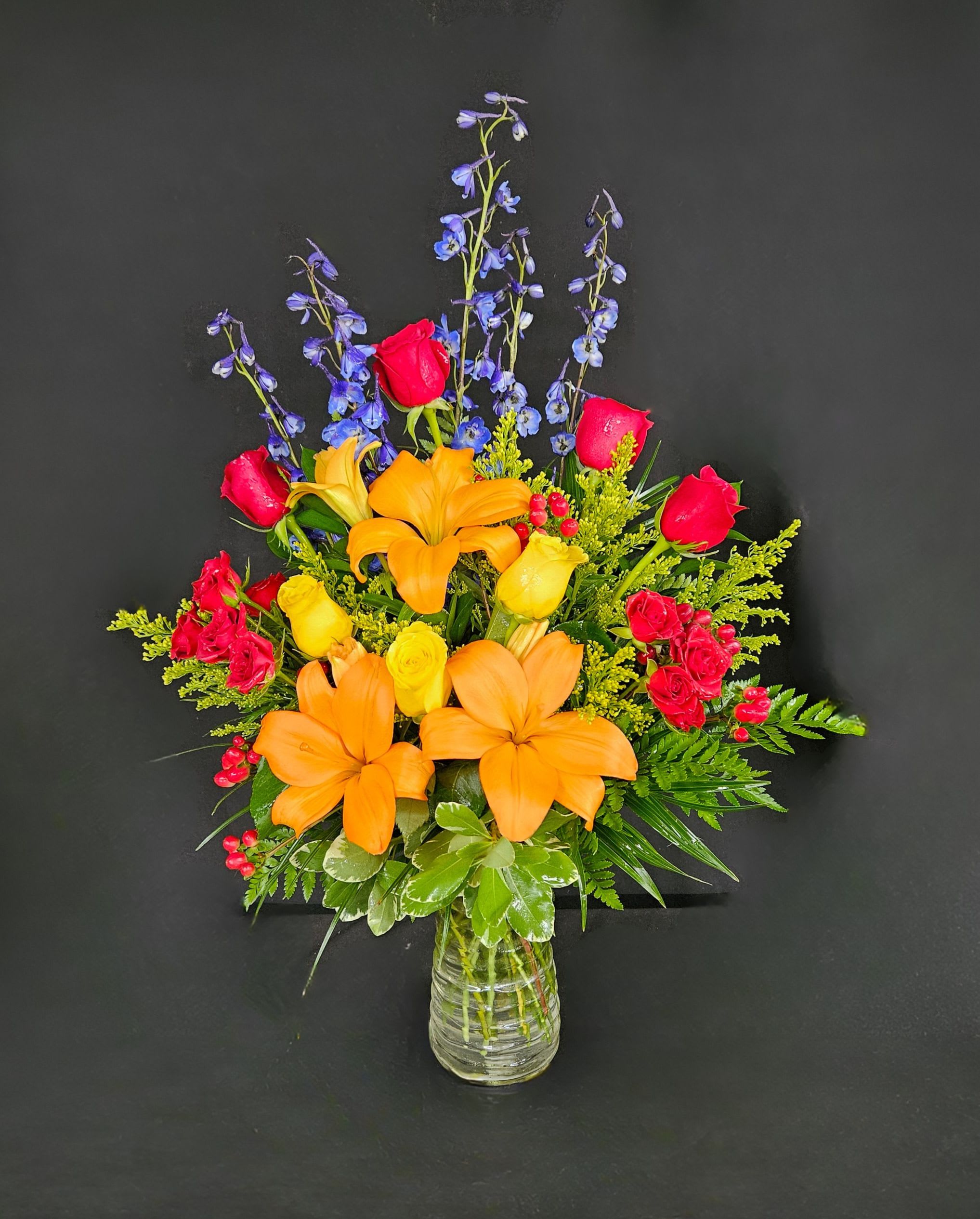 Ravishing Rainbow - A full rainbow of colors in this arrangement makes it a perfect arrangement to send to brighten up any space. A tall vase and height-defying flowers make it a great option for lifting someone's spirits.