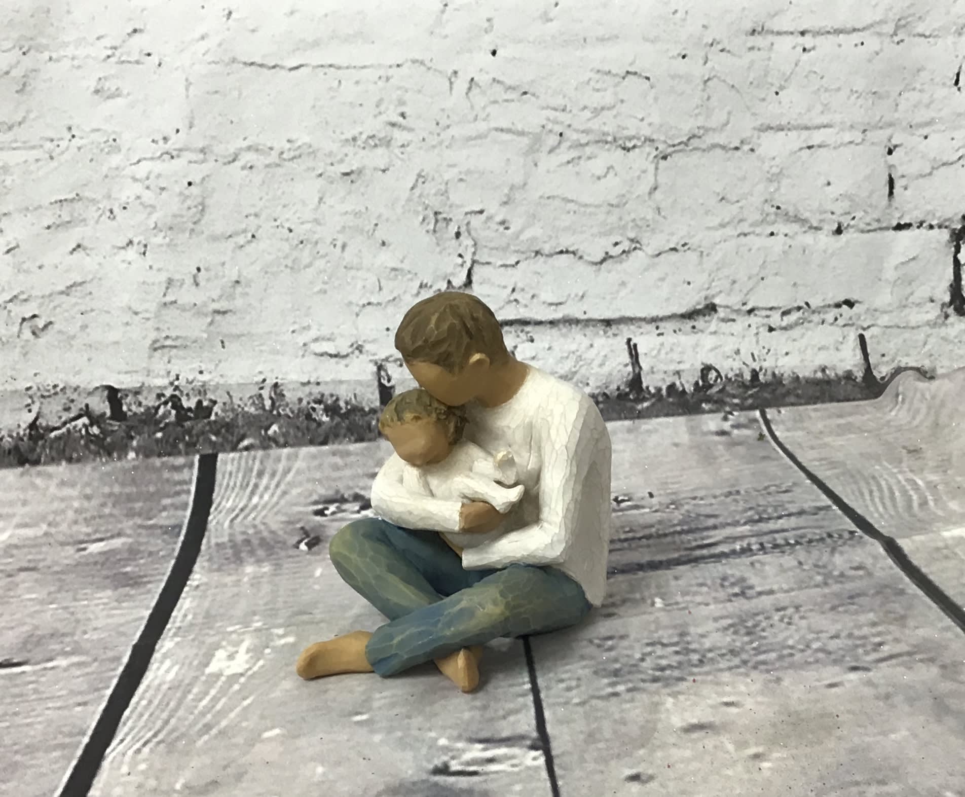 Small figurine of a person holding a child