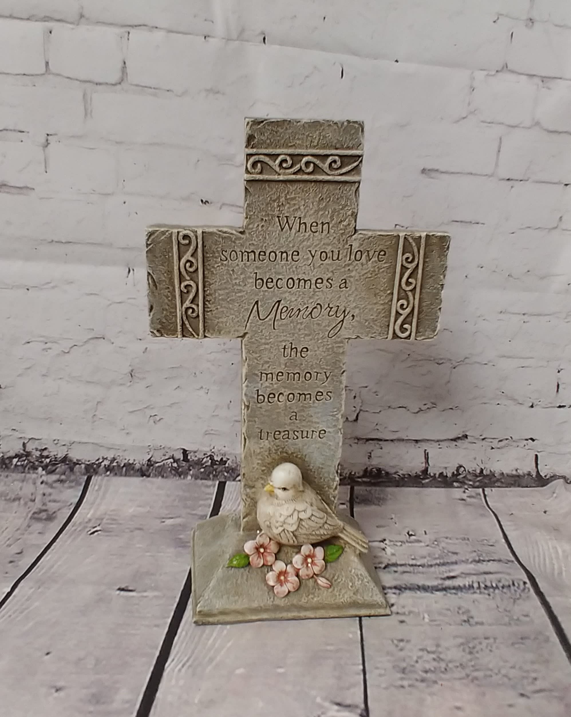 Decorative memorial cross with a bird and flowers