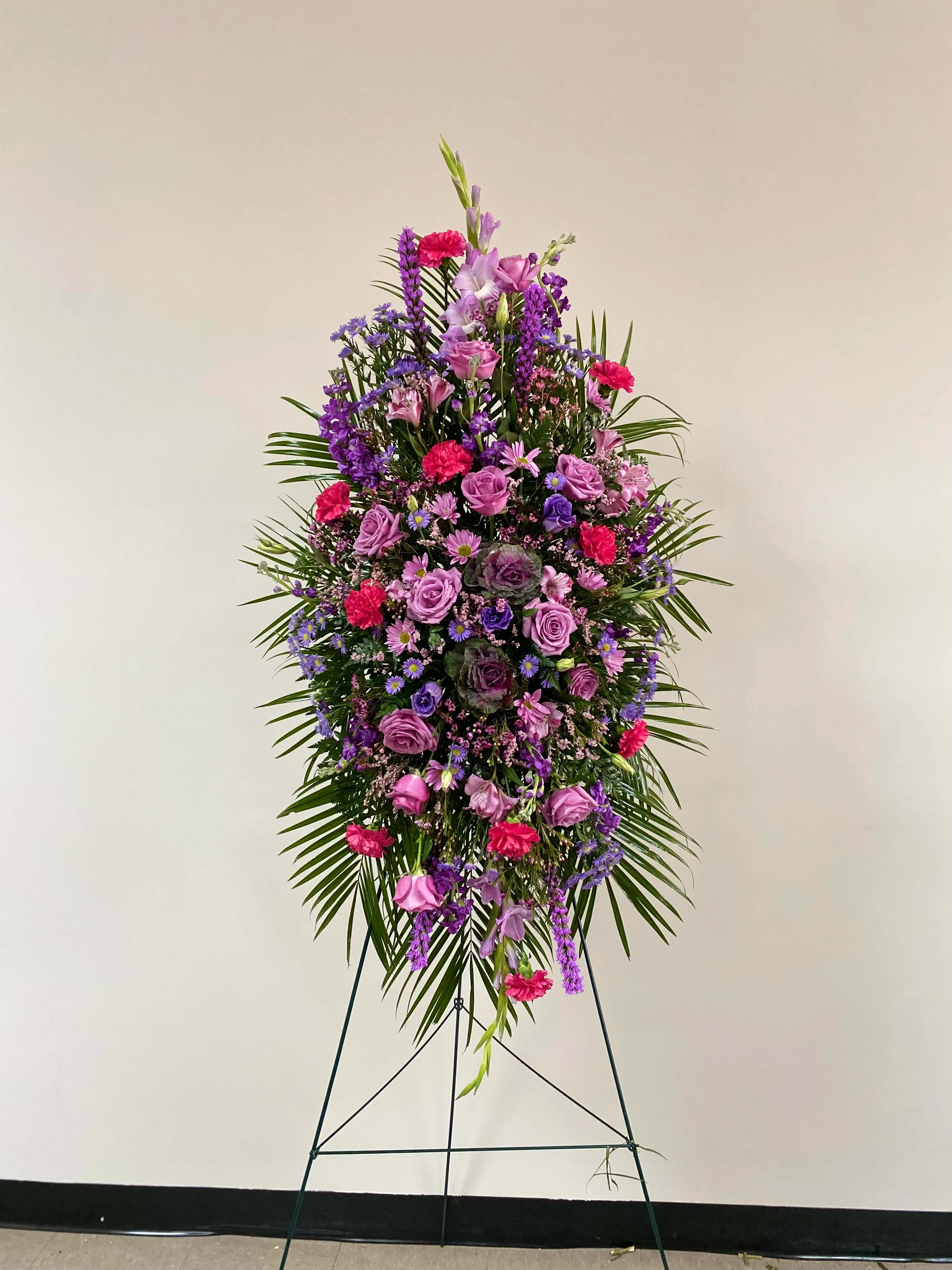 Tall standing floral spray in purple, pink, and magenta tones