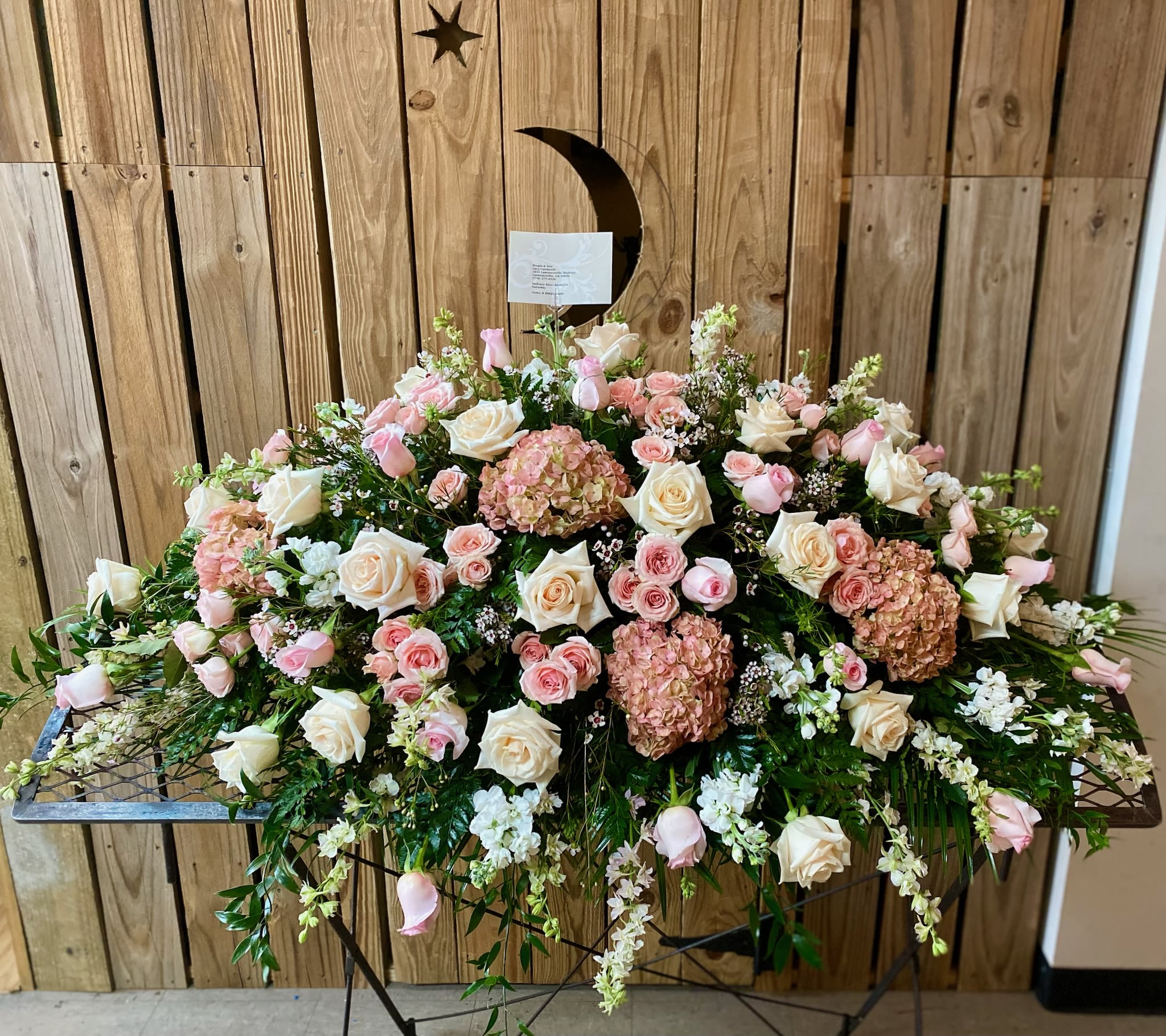 Large pink and white floral spray on a stand