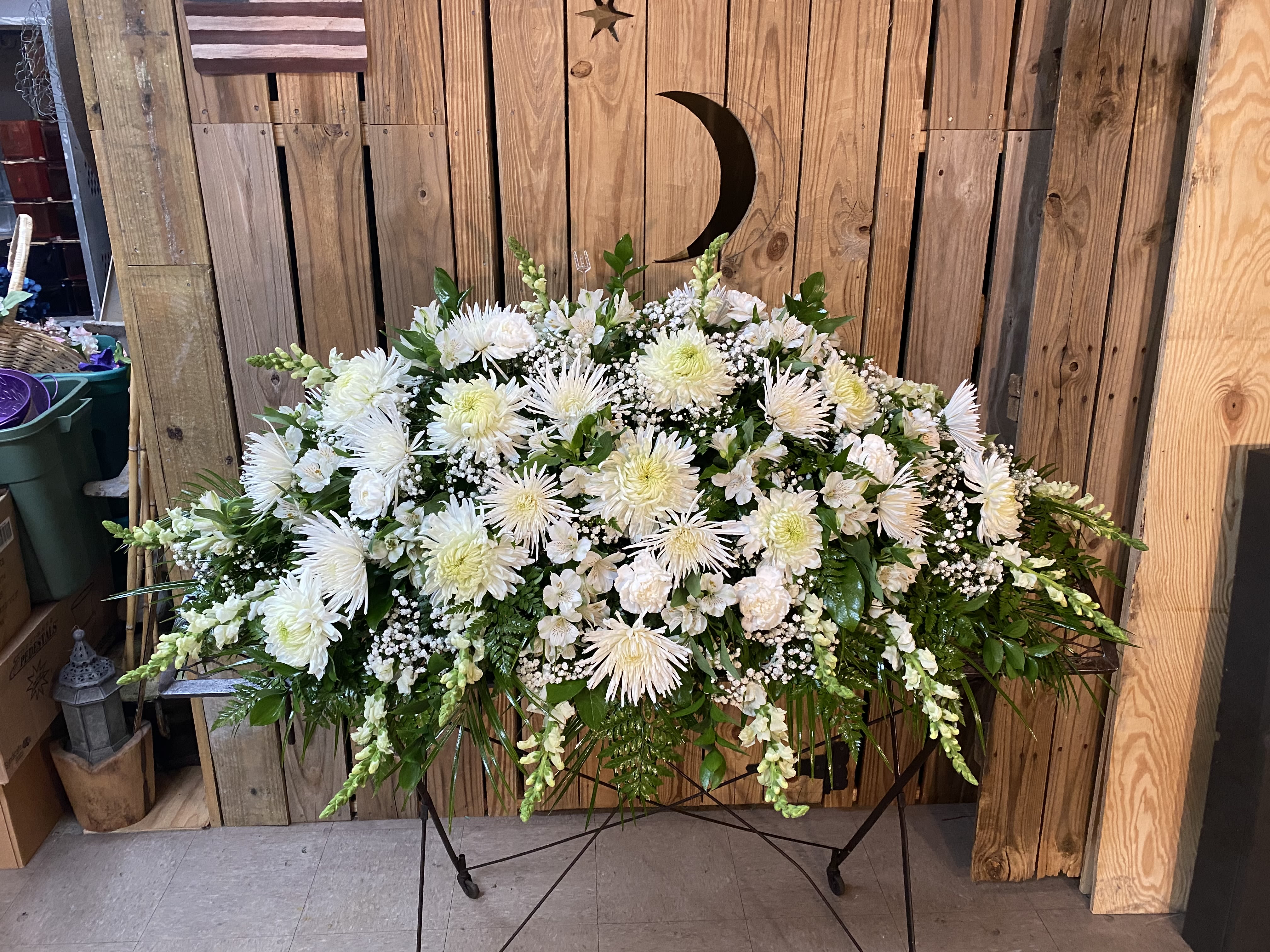 Large white floral spray on a stand