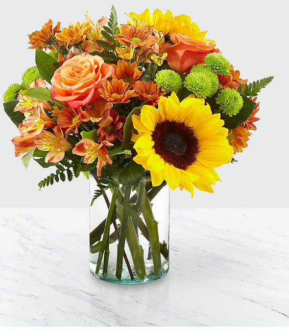 Autumn Splendor - Say hello to autumn with this bouquet filled with bold harvest hues and luscious blooms. Thoughtfully arranged with the freshness of fall in mind, a collection of orange roses, bright sunflowers and orange alstroemeria is set beautifully in a clear glass vase. Whether it's seasonal décor for your home or a gift for a loved one, our Autumn Splendor Bouquet is sure to make any home its placed in feel warm and bright. Bouquet sizes are approximate. 