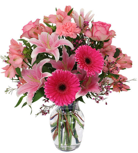 Pink mixed flower bouquet in a clear glass vase