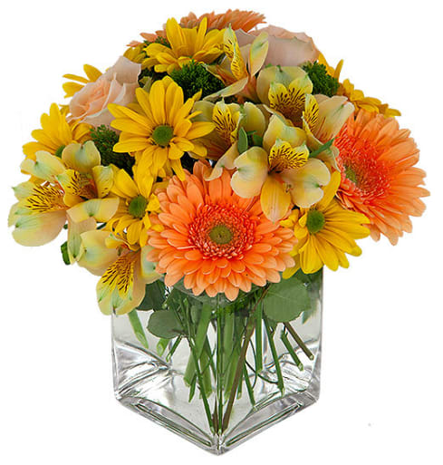 Bouquet of yellow and orange flowers in a clear glass vase