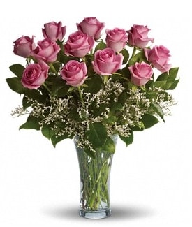 Pink roses arranged in a clear glass vase