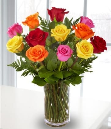 Colorful roses arranged in a clear glass vase