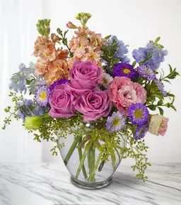 Mixed pink and purple bouquet in a clear glass vase