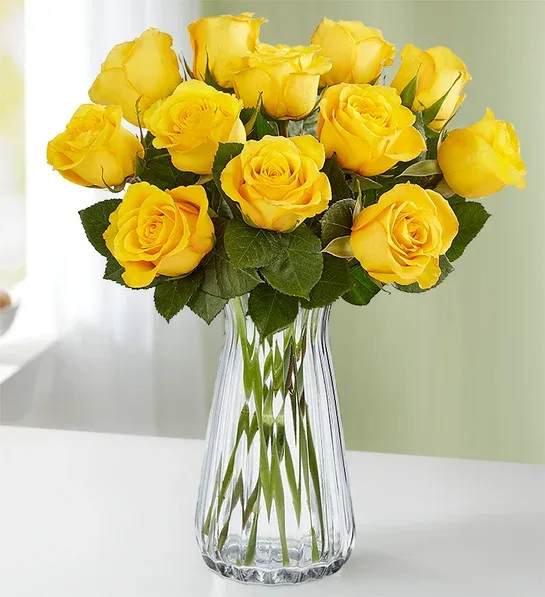 Yellow roses arranged in a clear glass vase
