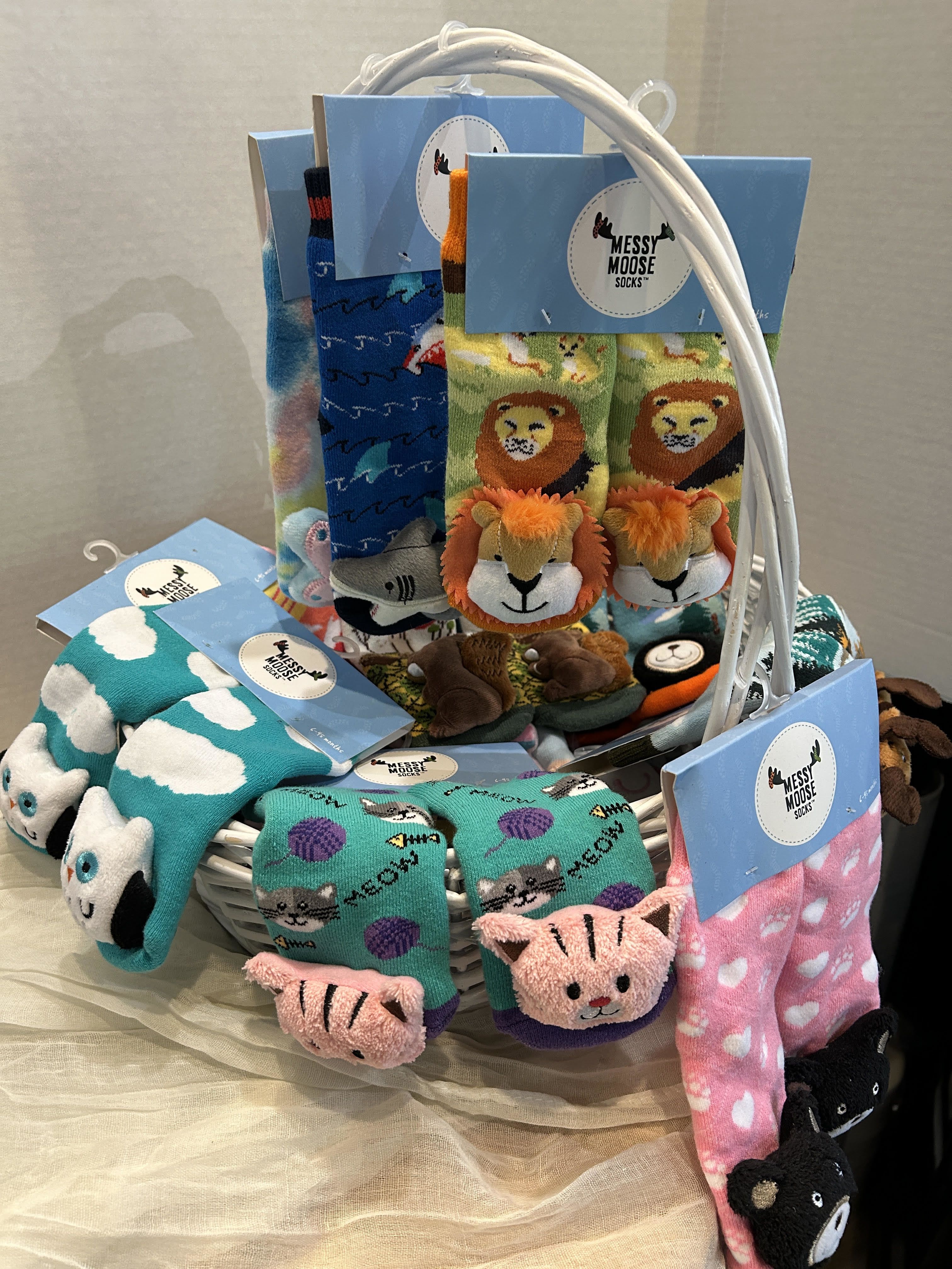 Basket of colorful animal-themed socks with blue tags