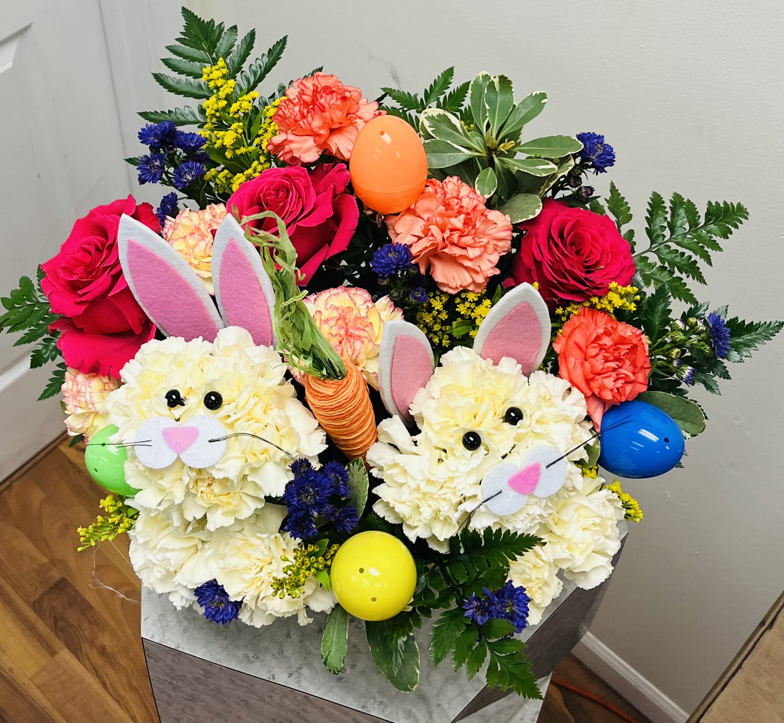 Colorful bouquet with roses, carnations, and bunny decorations