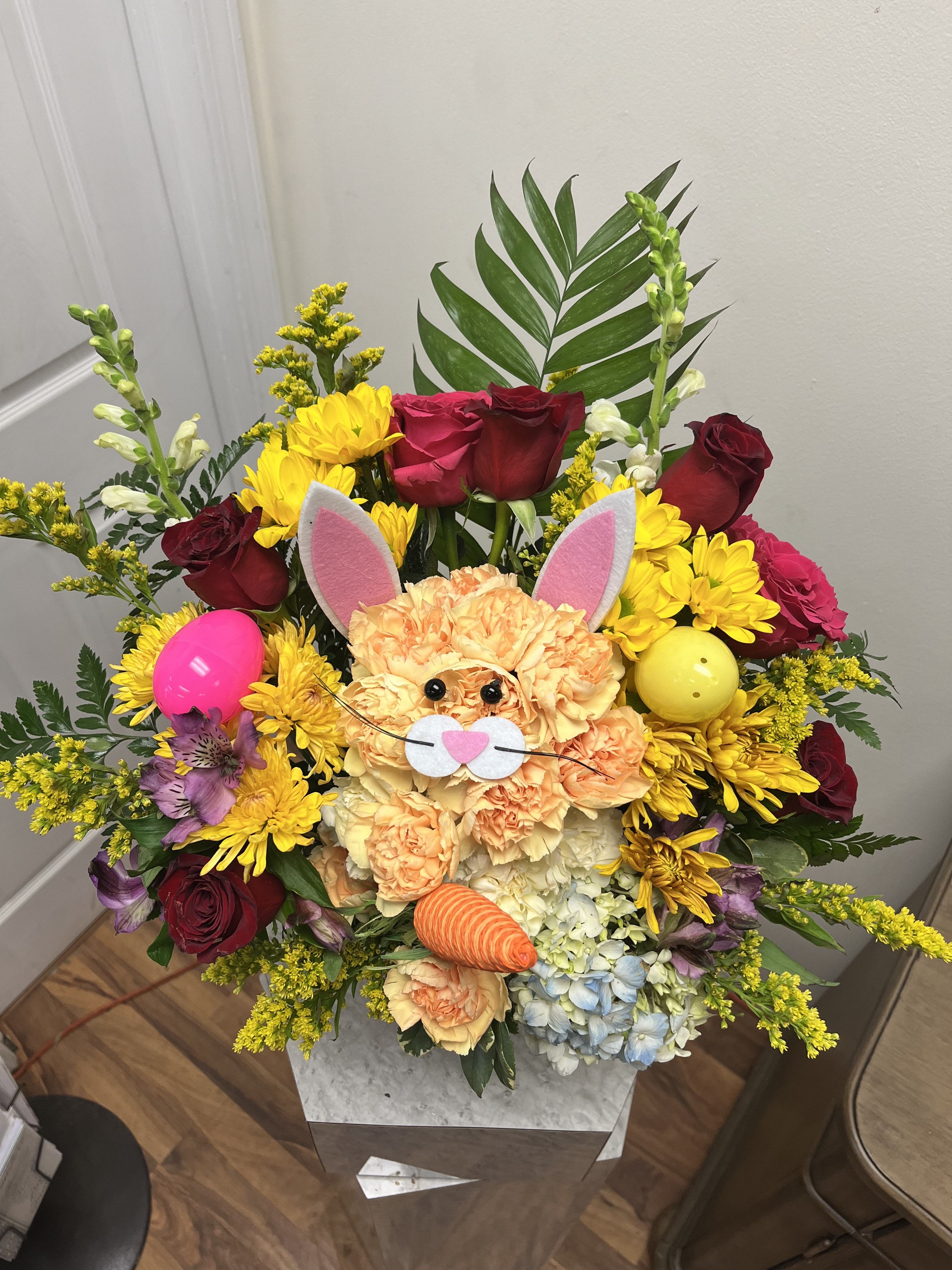 Colorful bouquet with a bunny face and Easter eggs