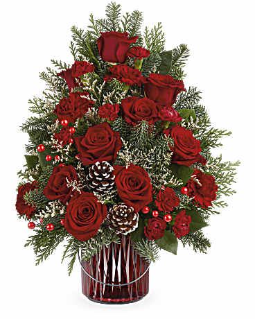 Red roses and pinecones arranged in a red glass vase