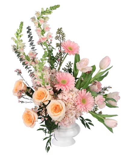 Pink and peach mixed flower arrangement in a white vase