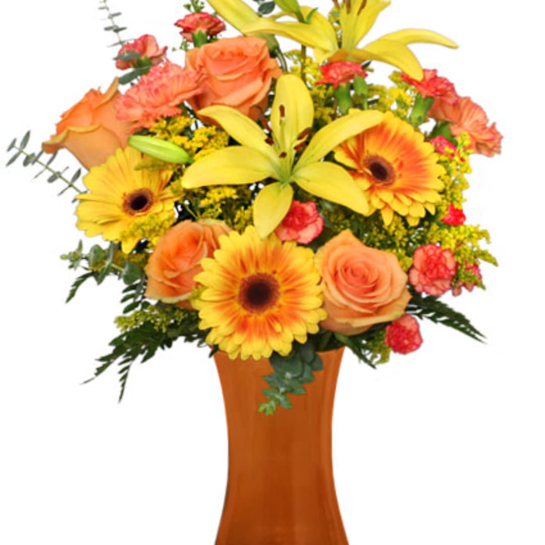 Orange roses and yellow lilies in a tall amber vase