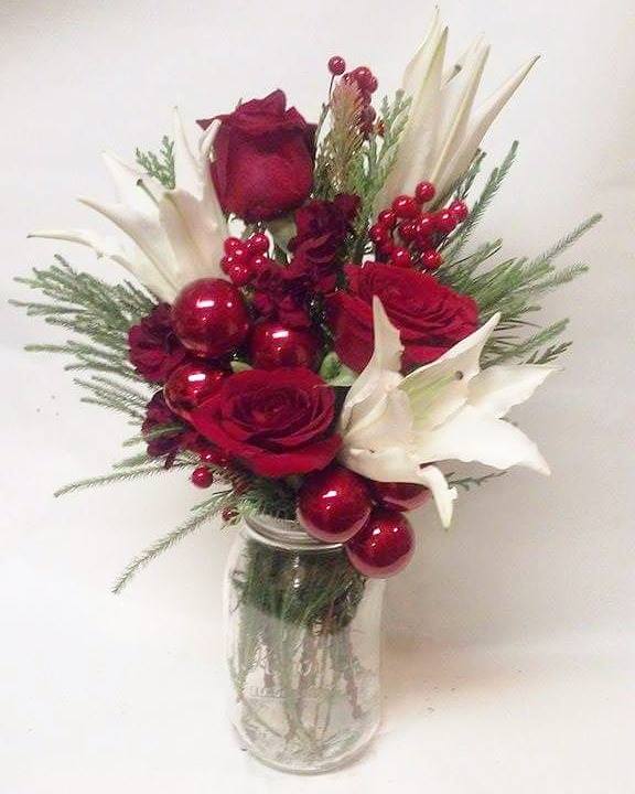 Lily and  Rose Ornament Mason Jar - Red roses White Oriental lilies, Berries, Ornaments and seasonal greens in a mason jar.