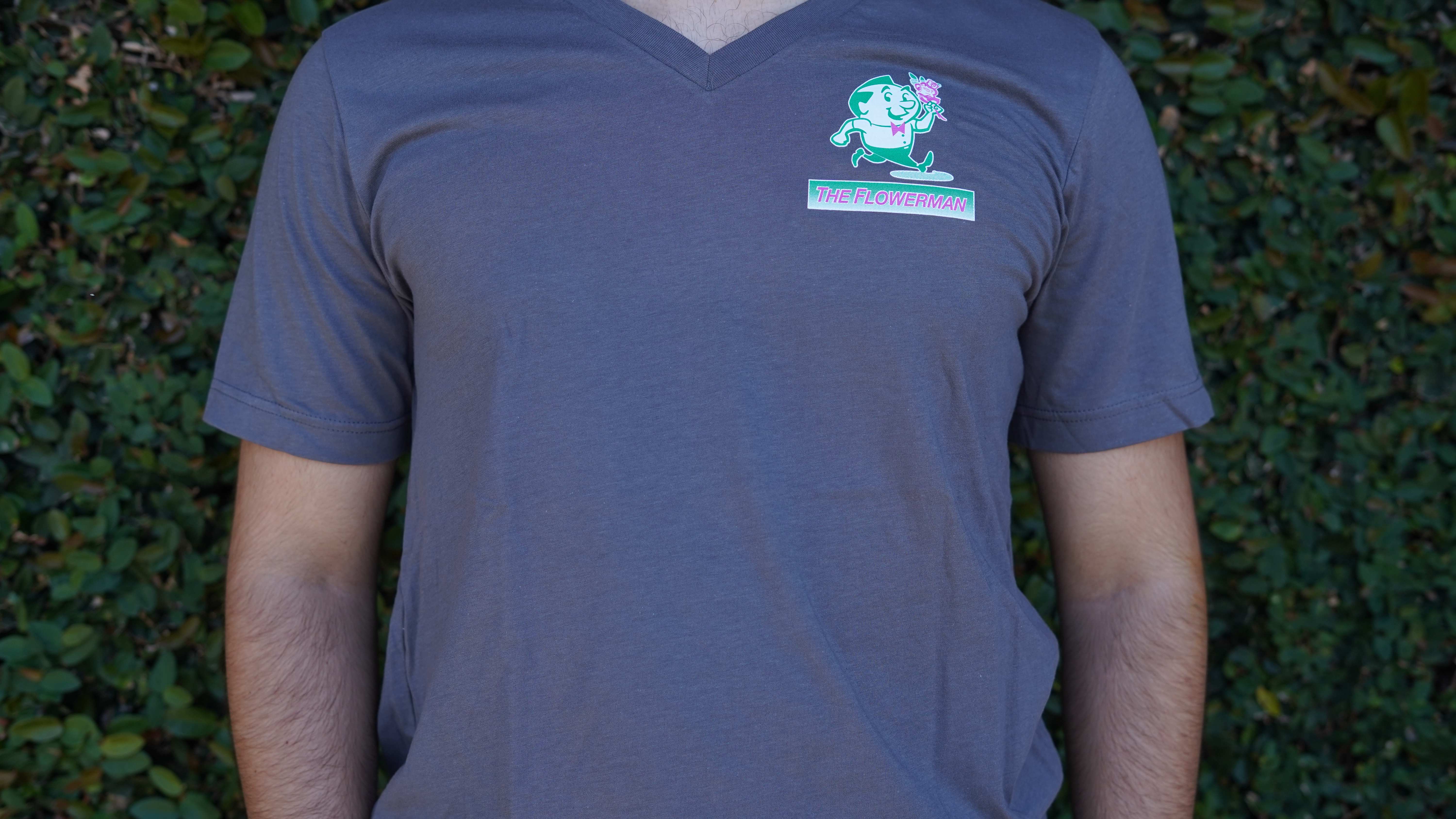 "The Flowerman" Logo Shirt - Introducing the all-new "The Flowerman" shirt! A heartwarming creation by "The Flowerman" florist. This shirt is not just an apparel piece; it's a symbol of love and support for your local business. Embrace style and community spirit with every step you take!  Crafted with care and attention to detail, the "The Flowerman" shirt offers an unparalleled level of comfort with its breathable fabric. The lightweight and soft material make it perfect for any weather, keeping you cool and fresh throughout the day. Designed to showcase your admiration for our small business, this shirt features "The Flowerman" florist's iconic mascot on the front and back of the shirt in many beautiful colors!  Spread the love and join "The Flowerman" florist in celebrating the beauty of community with this shirt. Together, let's blossom into a future where small businesses thrive, and our neighborhoods flourish with love and solidarity.      