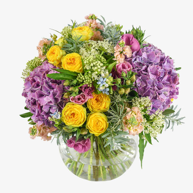 Sweet Moments Bouquet - A breath-taking assortment of seasonal flowers led by hydrangeas and spray roses with additions of lisianthus, stocks and other complimentary flower fillers.