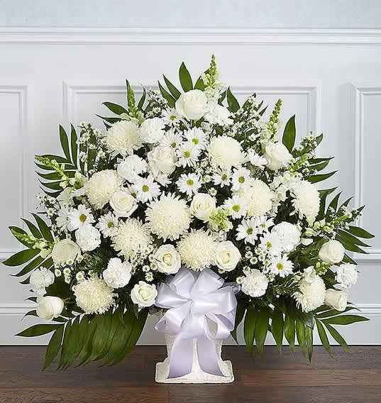 White Floor Basket Arrangement - There’s a feeling of peace and tranquility that white flowers can bring to those who are grieving. Our elegant all-white floor basket, handcrafted by our caring florists with lush white blooms, is a tasteful gesture perfectly suited for the funeral home or memorial services.All-white floor basket arrangement of roses, football mums, snapdragons, carnations, daisy poms and monte casino; accented with soft, lush greenery