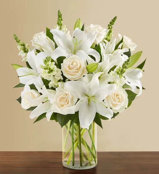 Classic All White Arrangement for Sympathy - White flowers have a timelessness and elegance that brings comfort during life’s difficult moments. Hand-gathered by our caring florists with touches of lush greenery, this classic arrangement beautifully conveys your heartfelt condolences.