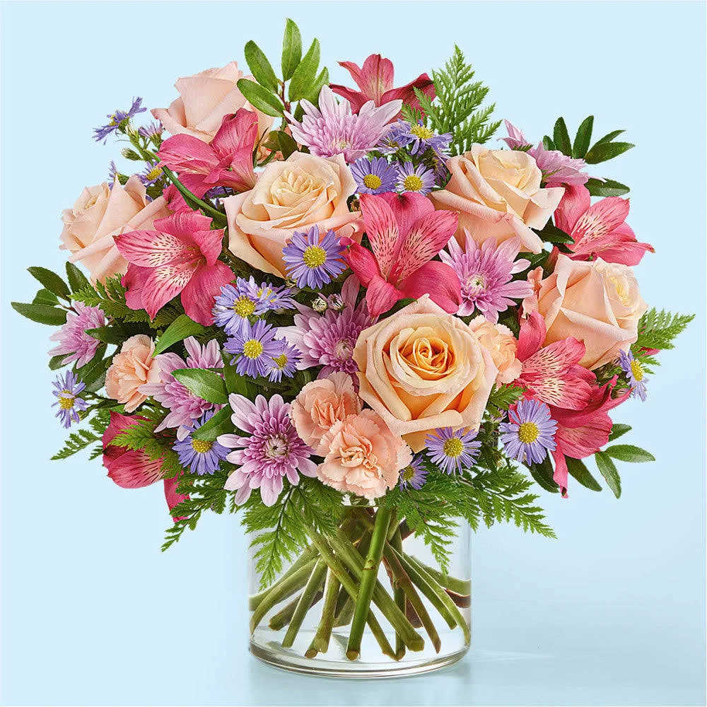 Sunse Bouquet - This pastel stunner is reminiscent of your favorite sunset, radiating warmth and tranquility through peach roses and lavender mums. 