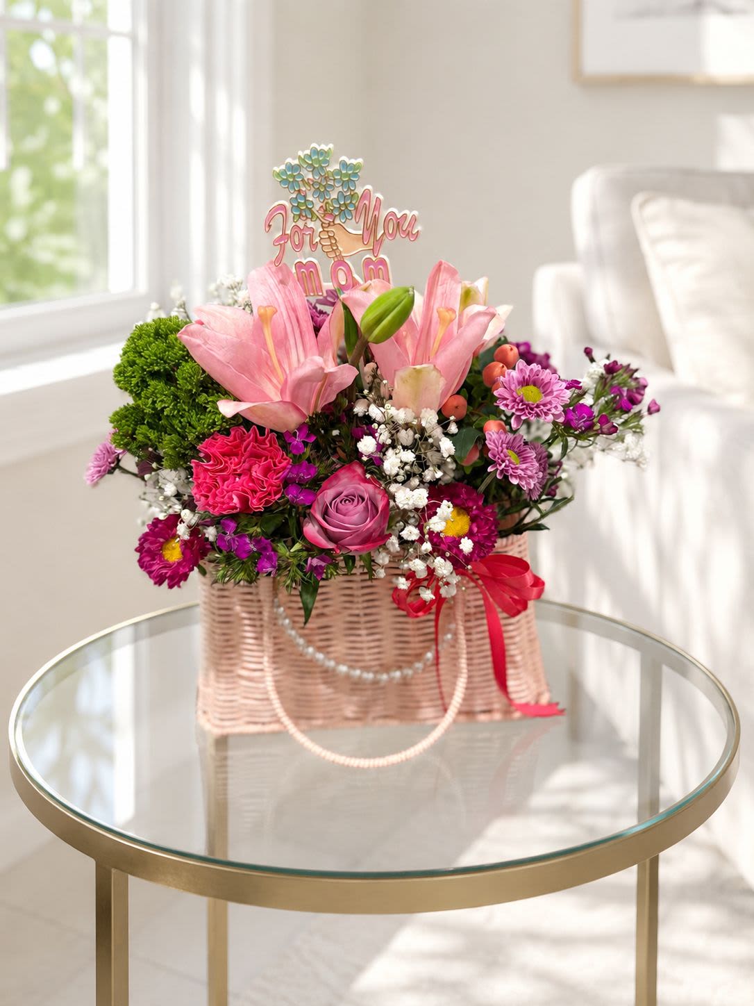 Mom's Spring Basket - Limited-edition Mother’s Day basket featuring fresh assorted blooms in an elegant wicker basket with faux pearl accents. Handcrafted in romantic pink tones, this one-of-a-kind design is the perfect heartfelt gift for Mom while supplies last.