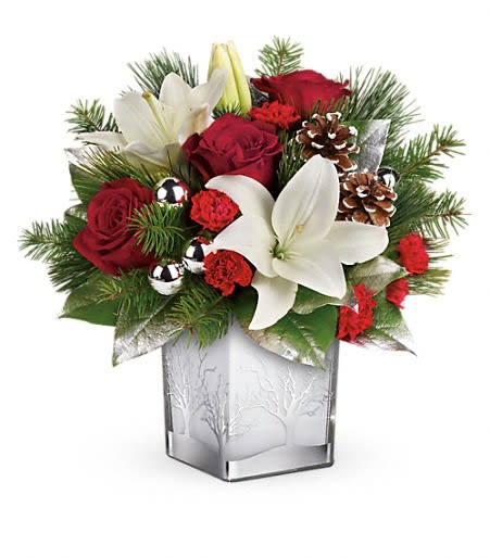 Teleflora's Frosted Forest Bouquet - With its festive charm and classic Christmas style, this hand-arranged bouquet delivered in a gorgeous glass cube with silver tree details is a delightful holiday surprise.