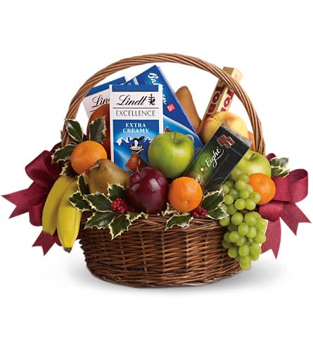 Fruits and Sweets Christmas Basket - Even if your gift list seems like it's endless this year sending anyone a sweet holiday gift is beautifully easy. This basket is fresh festive and fabulous. Oh and did we mention delicious? Fresh green red and yellow apples bananas grapes pears and tangerines are arranged with an assortment of gourmet chocolate bars and cookies. Add Christmas holly and red ribbons and you've got one heck of a healthy Christmas gift.Approximately 19" W x 16" H Please note: All of our bouquets and gift baskets are hand-arranged and delivered locally by professional florists. This item may require additional lead time so same-day delivery is not available. Orientation: N/A As Shown : T135-2ADeluxe : T135-2BPremium : T135-2C