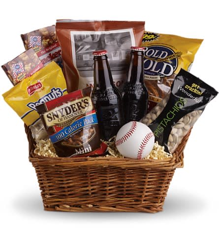 Take Me Out to the Ballgame Basket - Dads grads boys and baseball lovers of all ages will think you're an MVP when you send this winning basket. Full of ballpark favorites and more perfect for a picnic or a pick-up game in the park. You'll score a home run with this yummy basket that includes a real baseball of course. Peanuts pistachios Cracker Jacks three different kinds of pretzels and good old-fashioned root beer are teamed up in this basket. Anyone will have a ball with this gift!Approximately 16 1/2" W x 14 3/4" H Please note: All of our bouquets and gift baskets are hand-arranged and delivered locally by professional florists. This item may require additional lead time so same-day delivery is not available. Orientation: N/A As Shown : T108-1ADeluxe : T108-1BPremium : T108-1C