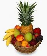 fruit basket - A cheerful fruit basket that's as festive as it is thoughtful - perfect as a get-well gift, housewarming surprise, or a casual thank-you. This fruit arrangement places an upright pineapple as a playful focal point, giving the recipient an immediate burst of sunshine and a bright tropical feel that suits birthdays, recoveries, or hostess gifts.  Arranged in a shallow woven basket, the composition is dense and colorful with ripe bananas, apples, grapes and other assorted fruit in vibrant yellows, reds, greens and oranges. The rustic basket adds homey charm and makes the gift easy to carry and display on a kitchen counter or dining table.  Send this when you want someone to feel noticed and nourished - it's the kind of gift that says "thinking of you" without formality. No special care is required beyond storing fruit at room temperature or in the refrigerator as needed; available sizes and delivery options can be selected at checkout.