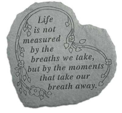 Gray stone plaque with a floral quote and vine illustration