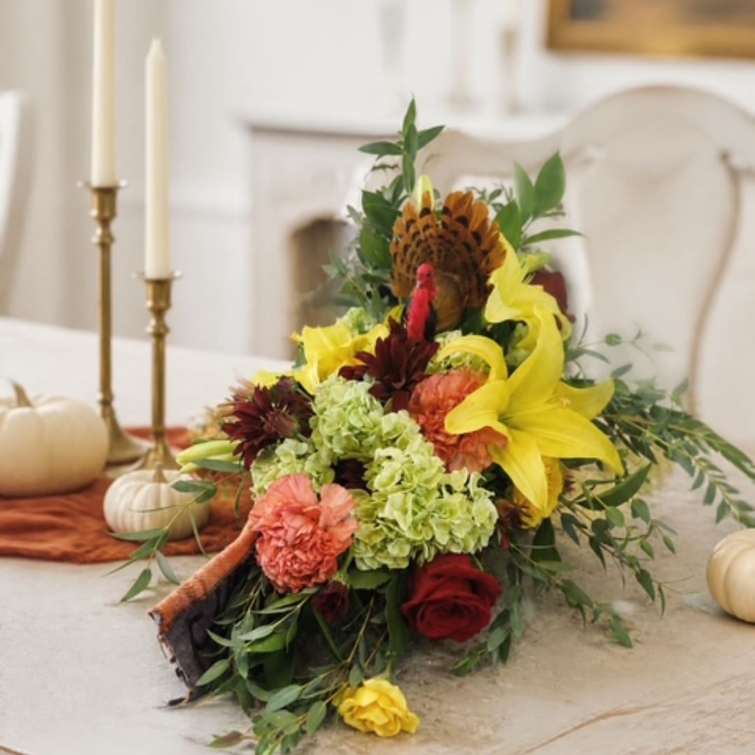 Autumn bouquet with yellow lilies, red roses, and green hydrangeas